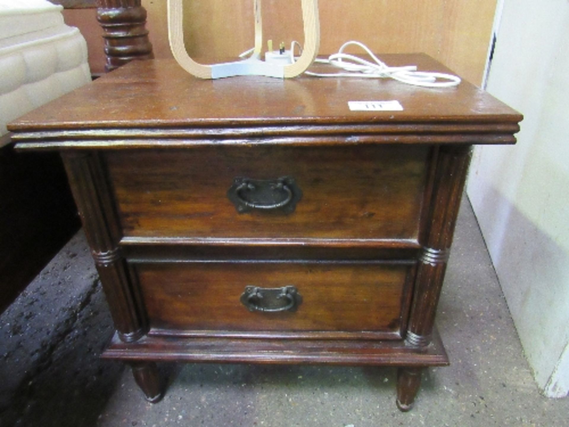 A pair of Indonesian hardwood bedside chests of 2 drawers