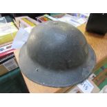 A Brodie 1930's Mark I* British Army helmet c/w original chin strap & liner in fair condition