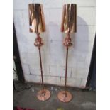 A pair of copper-coloured standard lamps & shades
