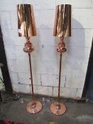 A pair of copper-coloured standard lamps & shades