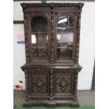 Victorian heavily carved glazed bookcase with double cupboard beneath, 56" (w) x 93" (h) x 22" (d)
