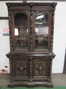 Victorian heavily carved glazed bookcase with double cupboard beneath, 56" (w) x 93" (h) x 22" (d)