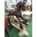 Dark wood rocking horse on stand