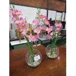 2 artificial pink orchids in glass vases