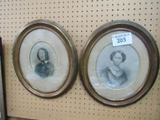 A pair of oval framed & glazed enhanced photographs of Victorian ladies