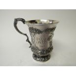 Silver Christening cup, heavily repousse decorated with trees & a figure of a man & his dog,