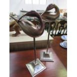 2 silver coloured bird ornaments