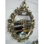 Ornately framed oval wall mirror, approx 42" x 32"