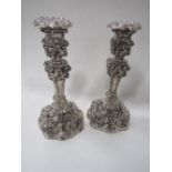 A pair of Rococco pattern Georgian silver candlesticks, London 1820 & 1825, c/w sconces