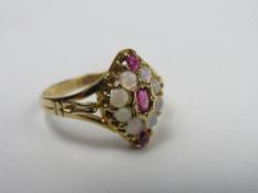 18ct gold ring with red stones & opal stones in an oval setting, weight 3.6gms, size R. Price