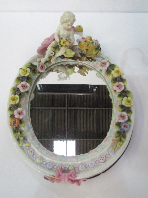 19th century Sitzendorf mirror decorated with flowers & putti. Price guide £50-60.