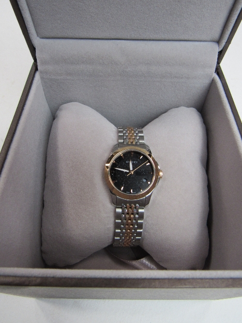 Lady's Gucci watch with metal bracelet strap, in box, going. Price guide £50-80.