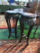 Pair of early 20th century ebonised carved plant stands with red marble centres, 77cms height. Price