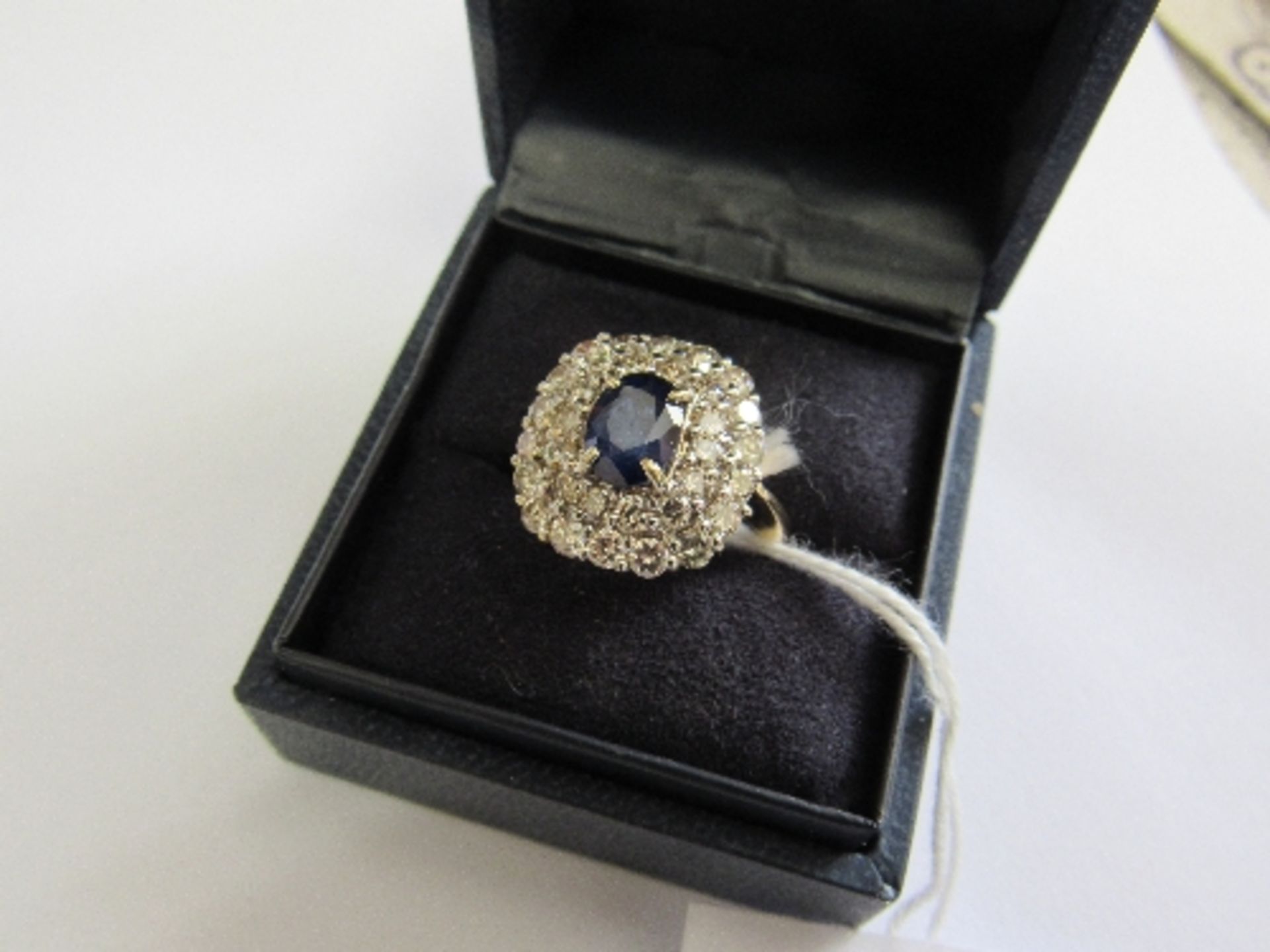 18 carat gold sapphire & diamond cluster ring, set with approx 1.5 carats of 8 cut diamonds. Price