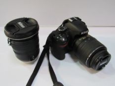 Nikon D3200 c/w additional lens, in case. Price guide £30-40.