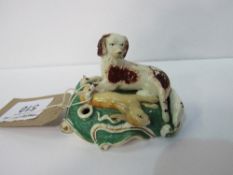 Early 19th century Staffordshire dog with hare pen holder. Price guide £40-60.