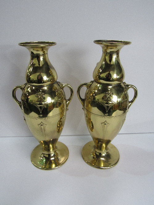 A pair of brass vases, 31cms height. Price guide £20-25.