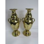 A pair of brass vases, 31cms height. Price guide £20-25.