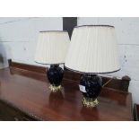 A pair of blue ceramic & brass table lamps & shades. Price guide £10-15.