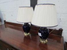 A pair of blue ceramic & brass table lamps & shades. Price guide £10-15.