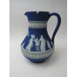 An early Jasper style Wedgwood jug, 18cms height. Price guide £40-50.