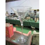 Tall funnel-shaped glass vase. Price guide £10-20.