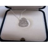10 carat white gold & diamond locket in the shape of a handbag, weight 2.0gms. Price guide £30-40.