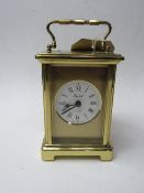 Bayard 8-day carriage clock, a wooden cased small mantle clock, silver metal cased clock & green