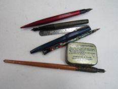 An assortment of ink pens, nibs, seals & other small objects