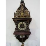 Dutch Zaandam ornamental pendulum wall clock with twin weights. Price guide £30-50.