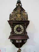 Dutch Zaandam ornamental pendulum wall clock with twin weights. Price guide £30-50.