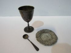 A silver small goblet, a silver condiment spoon, total weight 2.40ozt. A heavily decorated small