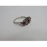 White metal lady's diamond & red stone ring, size M, wt 4.0gms. Price guide £220-250.