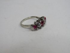 White metal lady's diamond & red stone ring, size M, wt 4.0gms. Price guide £220-250.