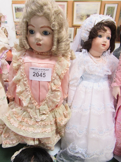 A porcelain doll in a wedding dress & another porcelain doll. Price guide £20-40.