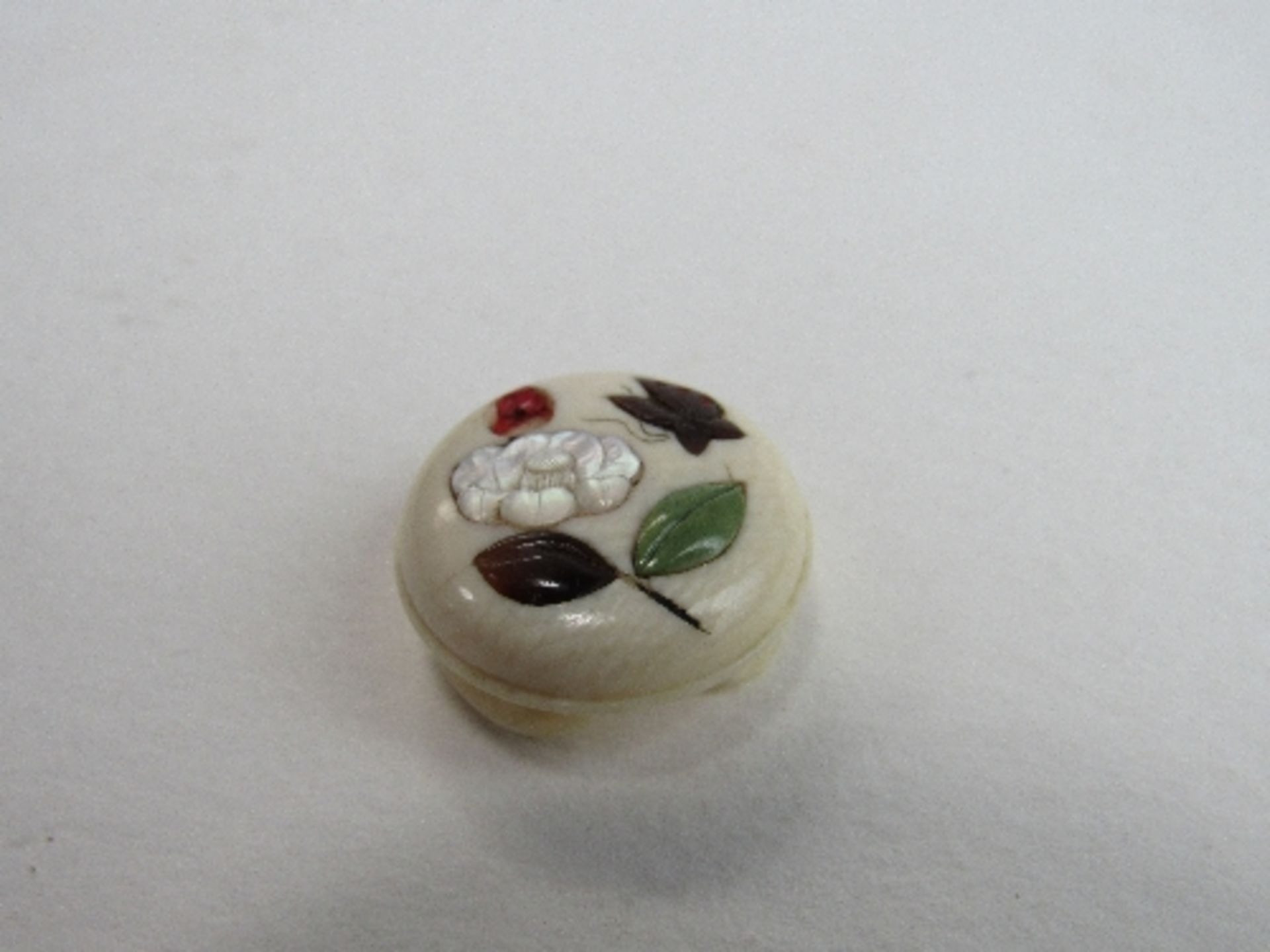 Circular ivory button decorated with mother of pearl & stone inlay of flowers & insects (1 flower
