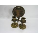 A late Victorian brass model tilt-top table & a pair of brass low candlesticks. Price guide £20-30.