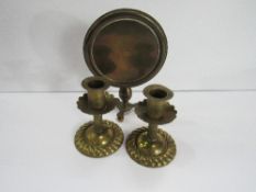 A late Victorian brass model tilt-top table & a pair of brass low candlesticks. Price guide £20-30.