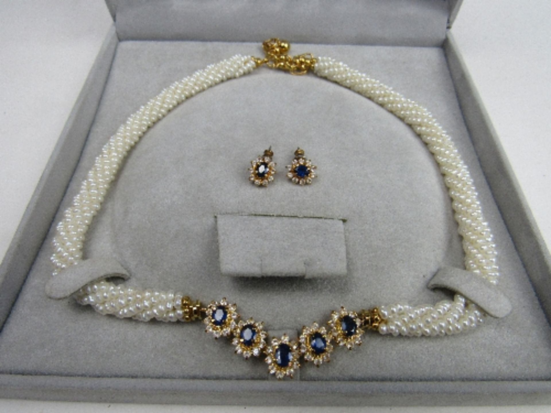 Pearl rope necklace with blue & white stones & a pair of matching earrings. Price guide £5-10.