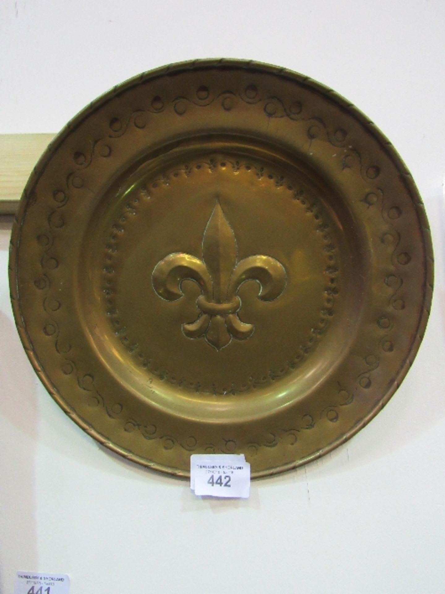 Brass charger with fleurs de lys decoration, 46cms diameter. Price guide £20-25.