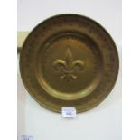 Brass charger with fleurs de lys decoration, 46cms diameter. Price guide £20-25.