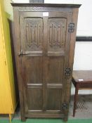 Oak single wardrobe with decorative hinges, 76cms x 51cms x 170cms. Price guide £20-30.