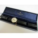 Garrard 9ct gold automatic, with date, men's wristwatch with new black leather strap, in box.