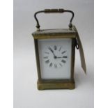 French brass cased carriage clock with white enamel face, going & c/w key.