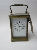 French brass cased carriage clock with white enamel face, going & c/w key.