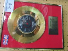 Framed & glazed reproduction of a 24ct gold coated presentation disc 'She Loves You' by The Beatles.