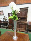 Tall silver metal vase & artificial flowers, 67cms tall. Price guide £10-20.