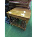 Nest of 3 oak tables. Price guide £10-15.