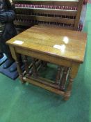 Nest of 3 oak tables. Price guide £10-15.