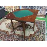 Edwardian mahogany envelope-type card table with display shelf, on casters, 78cms x 78cms x 71cms.